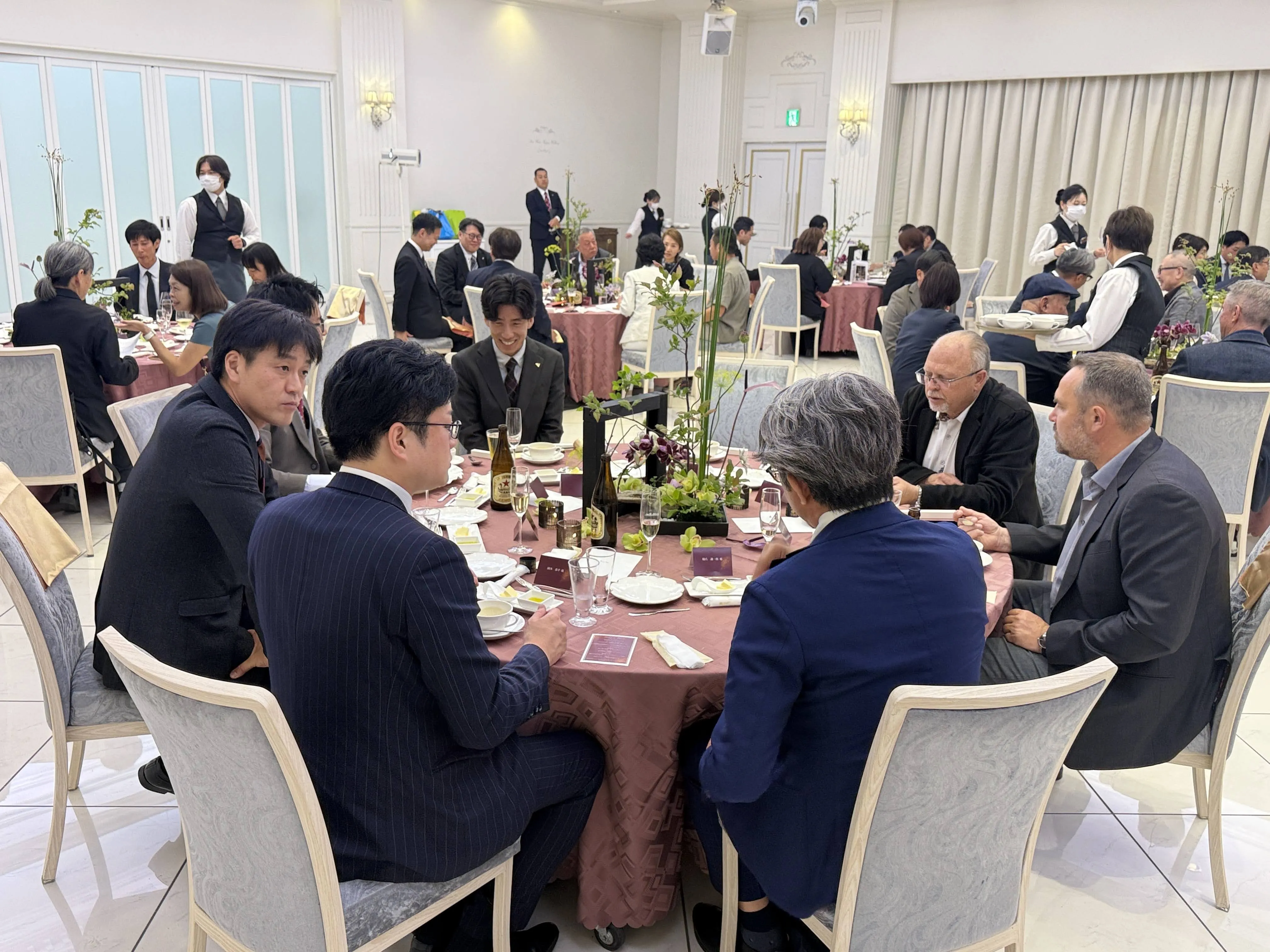 海外の葬祭関係者が食事しながら談合